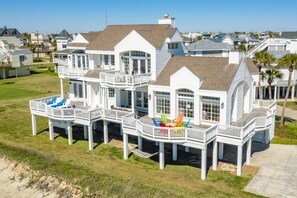 A large, multi-story house with multiple decks and a pool.