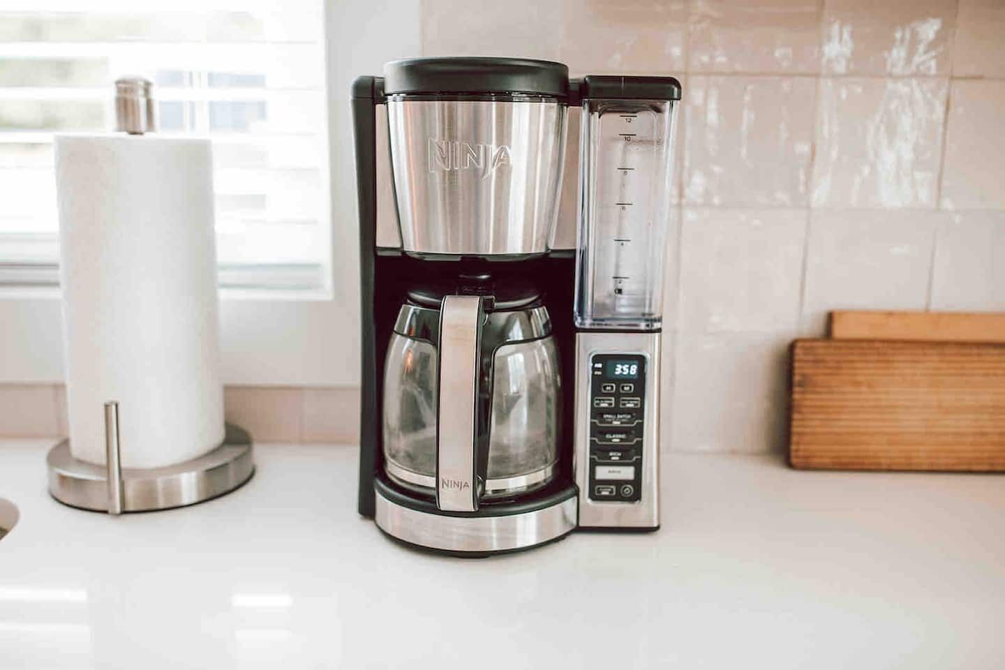 A kitchen with a coffee maker and a scale.