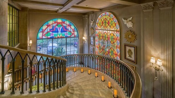 A grand staircase with ornate railings, large stained glass windows, and wall-mounted sconces. - Cannes City Hotel (Luzhou)