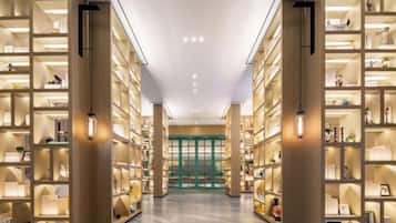 A library with bookshelves on both sides of a central walkway.