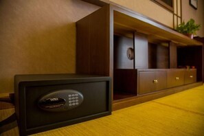 A room with a minibar, a minibar safe, and a wooden cabinet. - Yazhi Hotel (Qingyang)