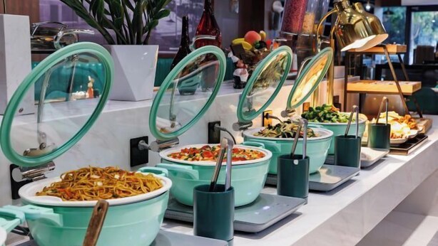 A buffet with various dishes in teal-colored serving bowls, each with a lid. - Gemei Hotel (Hefei China Sound Valley Zhongke University) (Hefei)