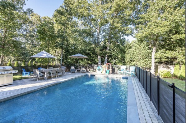 Relax by the pool surrounded by lush trees and enjoy a barbecue on the deck.
