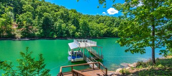 Waterfront home with game room, theater, deck, dock & fireplace