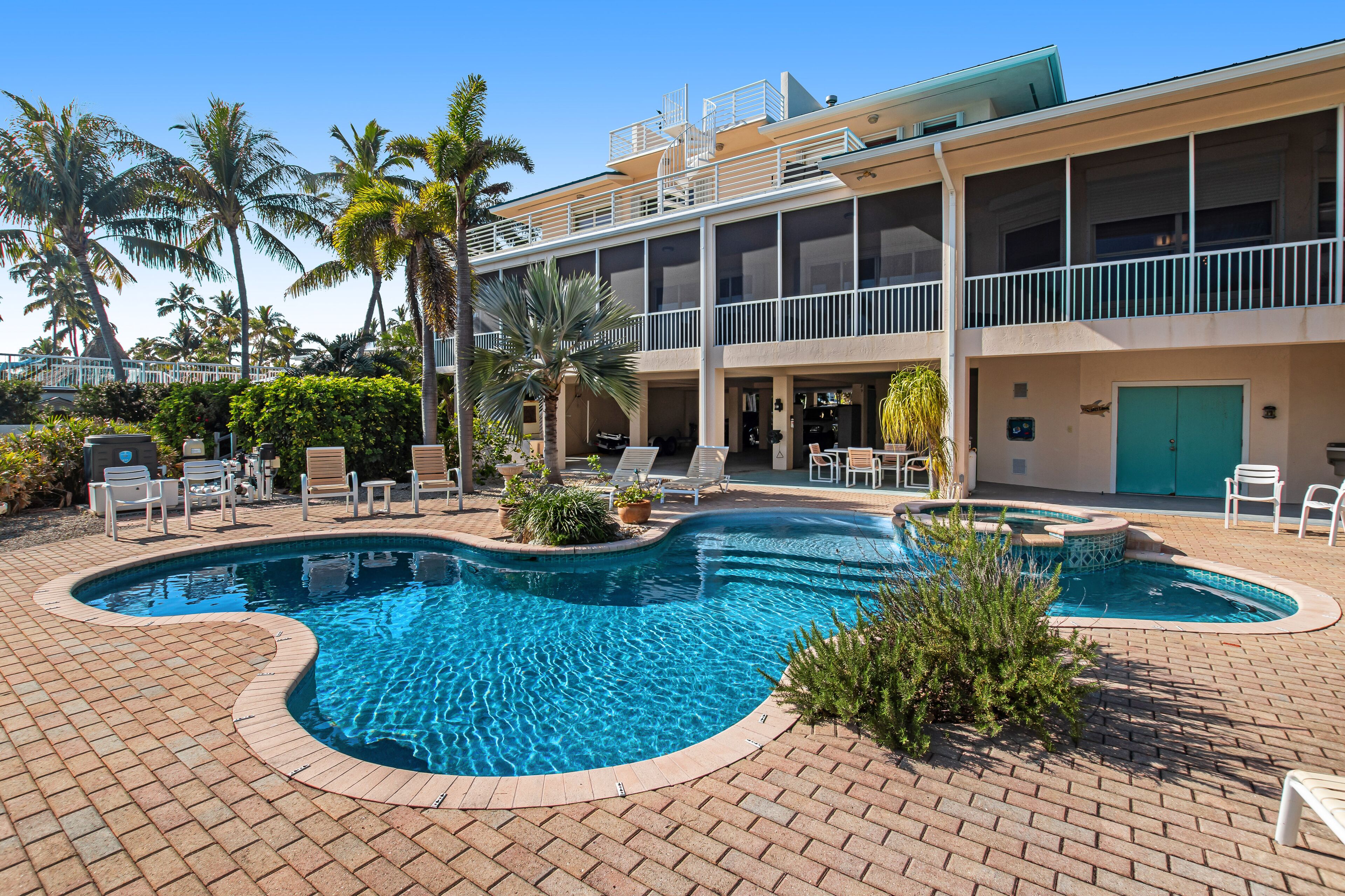 Opulent waterfront estate with dock, pool, hot tub & rooftop view - dog-friendly