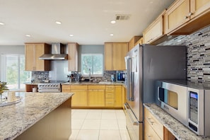 Fridge, microwave, oven, stovetop - Bright Escape with Private Pool, Easy Beach Access, Free WiFi & Open Layout (Juno Beach)