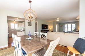 Relax in a spacious living area with a dining table, comfortable sofa, and flat-screen TV.