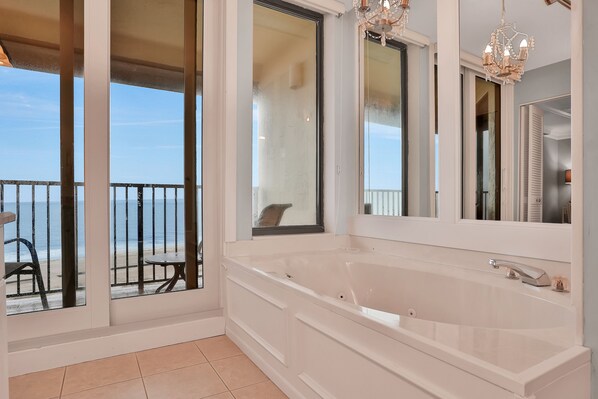 Relax in a serene beachside retreat with a spacious bathtub and expansive views.