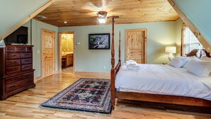 A bedroom with a wooden ceiling, a four-poster bed, a large rug, and a painting on the wall. - Blowing Rock Cabin | Hot Tub, Fire Pit, Fall Views (Blowing Rock)