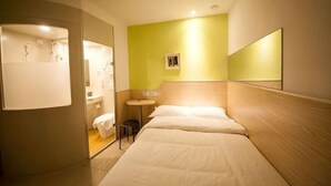 A hotel room with a bed, a small table, a chair, a mirror, and a bathroom visible through an open door. - 100 Inn (Fuqing Chenglong Pedestrian Street) (Fuqing)