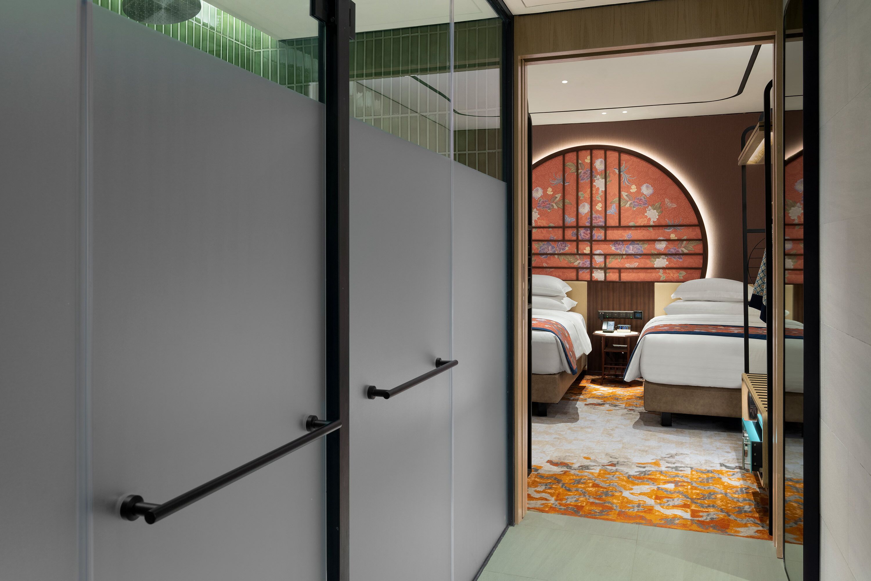 A modern hotel room with a large bed, a desk, and a view of a balcony.