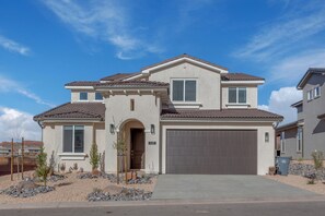 A two-story house with a garage, a small porch, and a landscaped front yard. - Paseos 1129 | Foosball Table, BBQ Grill, Xbox S, Community Trailer Parking & Pickleball Courts! (Washington)