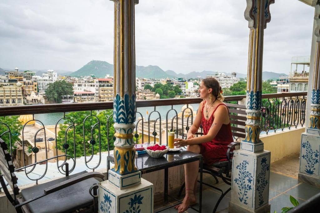 A balcony with a view of a cityscape and mountains.