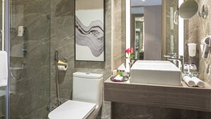A modern bathroom with a glass-enclosed shower, a toilet, a sink with a mirror, and a marble floor. - Aber Khamis Mushait (Khamis Mushait)