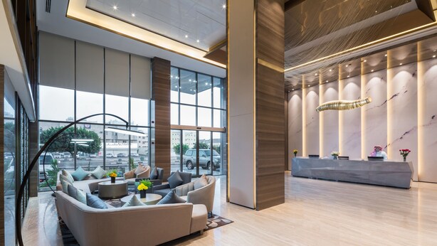 A modern lobby with a seating area, large windows, and a reception desk. - Aber Khamis Mushait (Khamis Mushait)