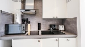 A modern kitchen with a microwave, toaster, and coffee maker.