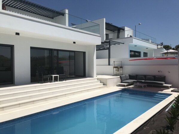 A heated pool, sun loungers