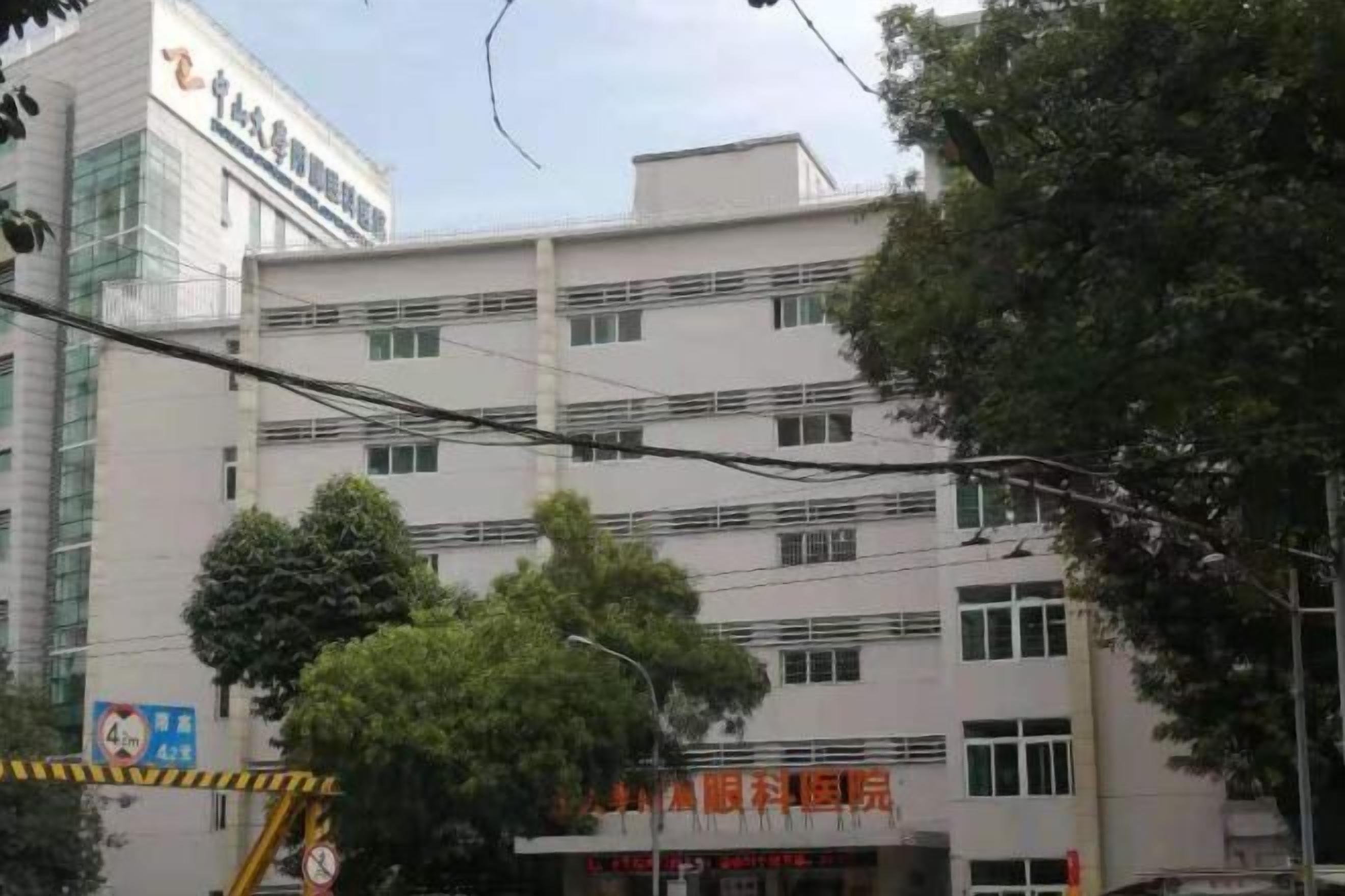 A multi-story building with a flat facade, several windows, and a visible entrance.