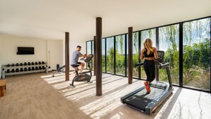 A modern gym with treadmills, dumbbells, and exercise equipment.