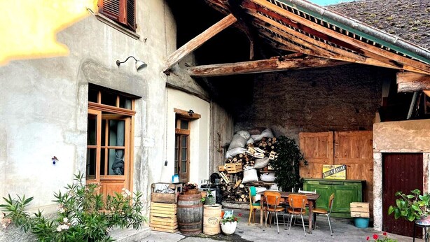 A rustic outdoor area with wooden furniture, barrels, and potted plants. - Family home in the country (groslee saint benoit)