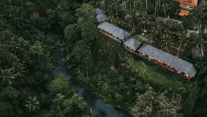 An aerial view of a resort with a long building, a swimming pool, and a river. - Exceptional 9BR Incredible Jungle View, River Access (Ubud)