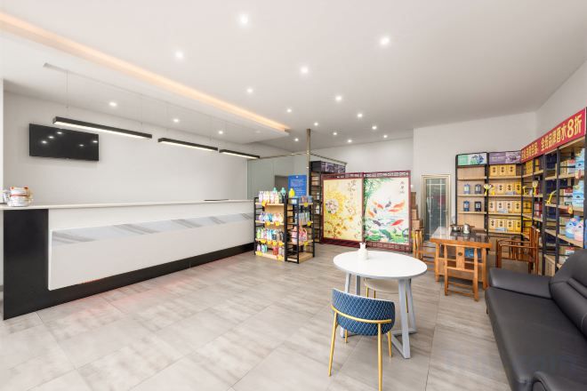 A reception area with a counter, seating, and a bookshelf.
