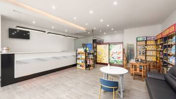 A reception area with a counter, seating, and a bookshelf.