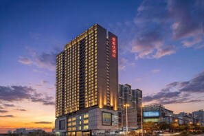A high-rise hotel with multiple floors, large windows, and a prominent sign on the side. - Sihui Aikeyou Hotel (Sihui Plaza) (Sihui)