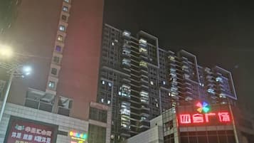 A multi-story building with illuminated signage, likely a hotel or commercial property.
