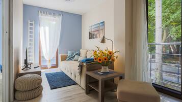 Standard Apartment | Living area | 40-inch flat-screen TV with cable channels, TV