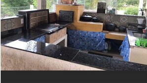 A kitchen with a brick oven, a sink, and a countertop.