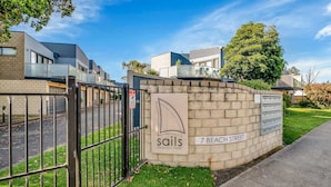A gated residential area with a sign for 'Sails on Beach Street' and a mailbox. - Starfish Sands in Cowes (Cowes)