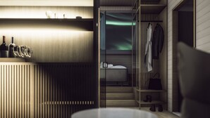 A modern hotel room with a wooden wardrobe, a bed with white linens, and a view of the Northern Lights. - Aurora Collection Saariselkä (Saariselka)