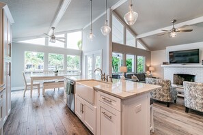 Enjoy cooking in the well-equipped kitchen with a large island, sink, and ample counter space, then dine or relax in the adjacent seating areas.