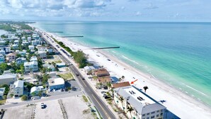A coastal town with a beach, buildings, and a road. - Beachfront Rental with Ocean Views, Close to Restaurants and Shopping! (Bradenton Beach)