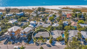 An aerial view of a coastal residential area with houses, some under construction, and a beach in the background. - Quiet North End Home Only 2 Blocks to Beach with Private Pool (Anna Maria)