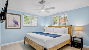 A bedroom with a bed, two bedside tables, a ceiling fan, and two windows with blinds. - Duplex with Heated Pool! 2 Blocks to Beach! - Turtle Crawl (Anna Maria)