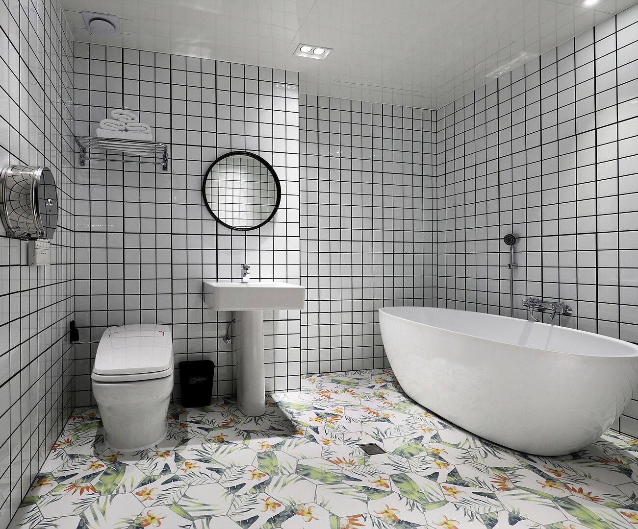 A bathroom with a toilet, sink, and freestanding bathtub.