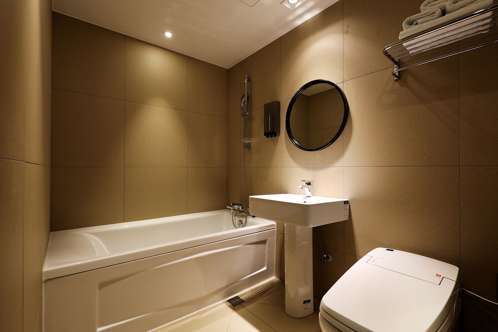 A modern bathroom with a bathtub, a sink, and a toilet.