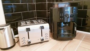 A kitchen with a toaster and a coffee maker on the counter.