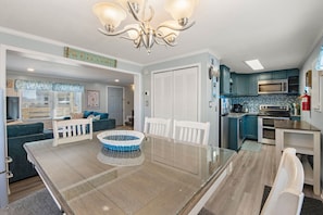 Enjoy meals in the kitchen and dining area, featuring an oven, microwave, and glass-top table.