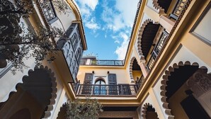 A courtyard with traditional architecture, including arches and balconies. - Riad Ambre & Epices Marrakech (Marrakesh)