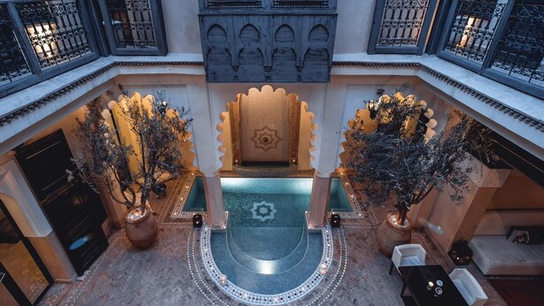 A courtyard with a central fountain, ornate railings, and potted plants. - Riad Ambre & Epices Marrakech (Marrakesh)