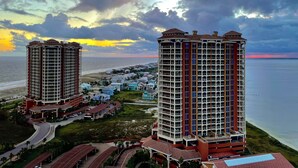 A high-rise hotel with multiple floors, a beach view, and a parking area. - Great for families! Portofino 2-1908 (Pensacola Beach)