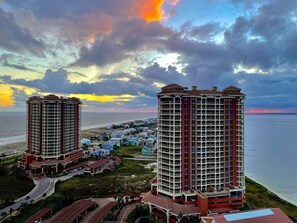 A high-rise hotel with multiple floors, a beach view, and a parking area. - Great for families! Portofino 2-1908 (Pensacola Beach)