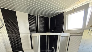 A bathroom with a toilet, a shower enclosure, and a sink. - Honor A Pansiyon Side (Manavgat)