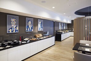 Relax in a stylish space with a dining table, comfortable seating area, and abstract art.