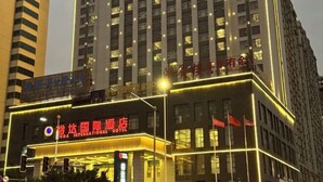 A hotel with multiple floors and a prominent sign for the UDA International Hotel.
