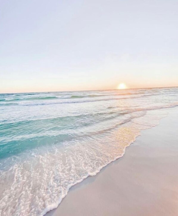 A beach with waves gently lapping onto the shore.