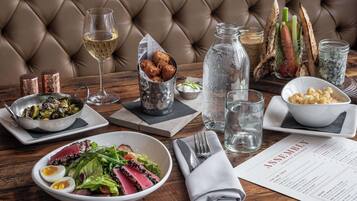 A dining table with various dishes, a menu, and a bottle of water.